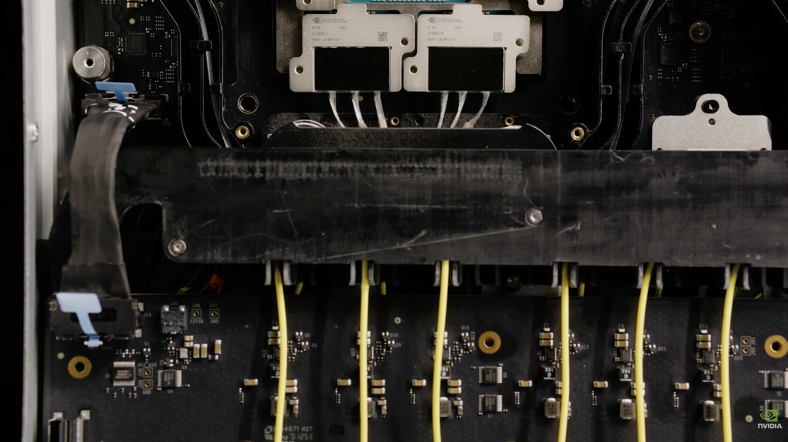 Internal fiber routing inside the Q3450 — fibers run from the photonic packages toward the front-panel MMC connectors